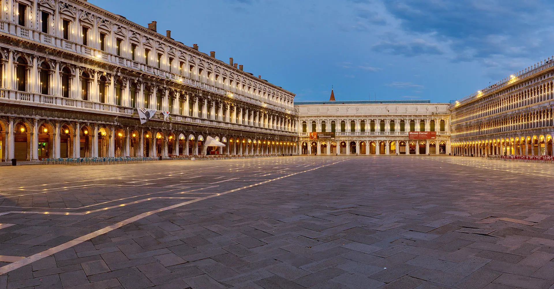 Arcaded piazza with illuminated colonnades at dusk