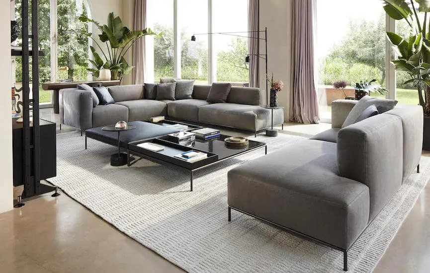 cassina furniture in a living room with view on the garden