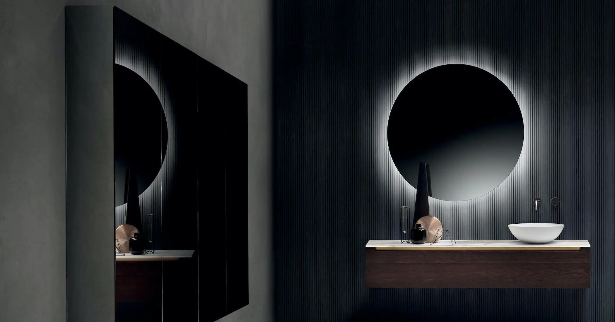 Falper bathroom with round backlit mirror, wood vanity unit and round countertop washbasin