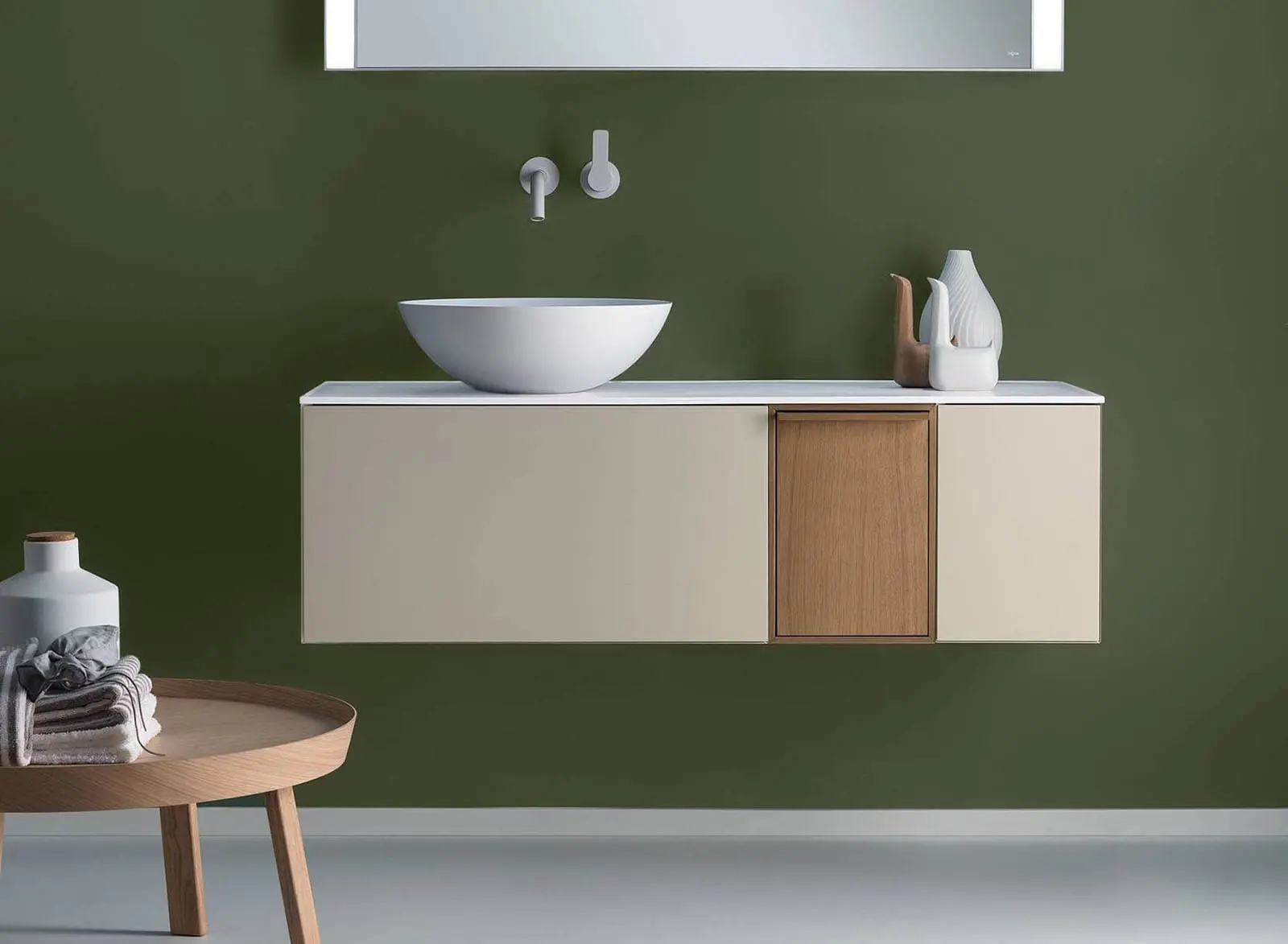 Falper wall-hung vanity with a round countertop basin against a green wall