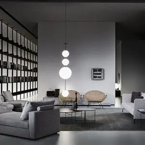 Modern living room with grey corner sofa, black shelving wall and round pendant lights