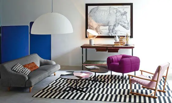 Living room with blue folding screen, grey sofa, purple armchair and rhino artwork