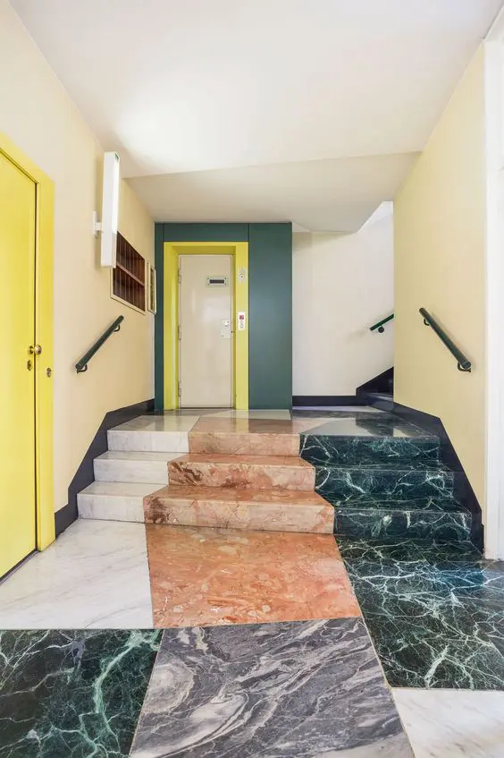 Apartment hallway floor with marble, travertine and terrazzo pattern and yellow doors