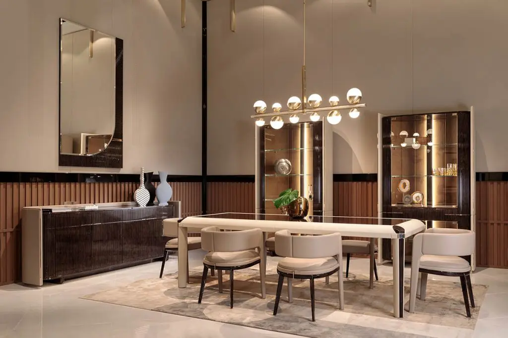 Turri Eclipse dining room with a white table, taupe chairs, mirrored cabinets and a spherical chandelier