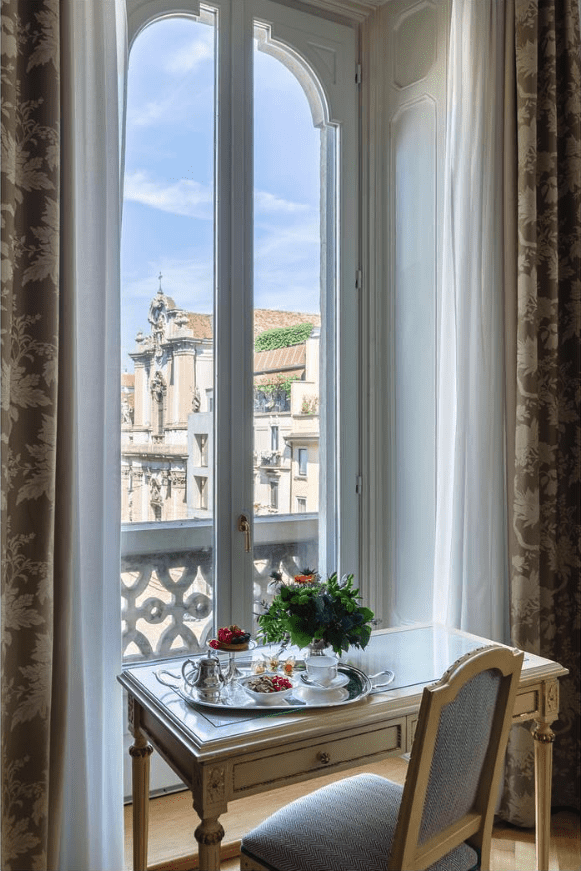 Breakfast tray by a window overlooking Milan rooftops