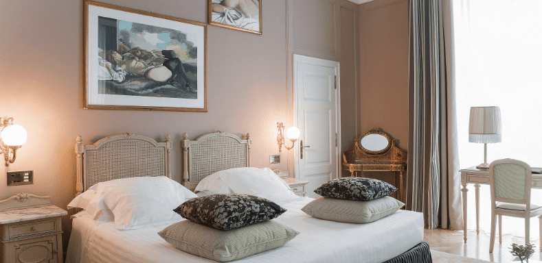 Bedroom with cane headboards and framed artwork on the wall