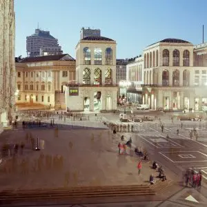 Piazza del Duomo at dusk with the Galleria entrance lit up