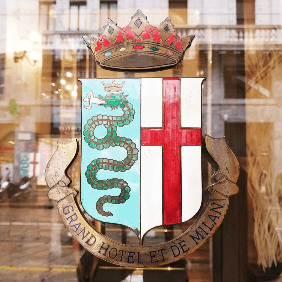 Crest reading Grand Hotel et de Milan on a glass door