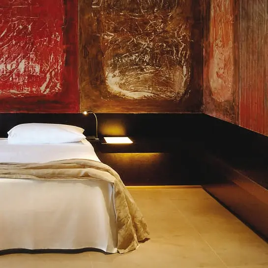 Bedroom with scorched red and copper textured wall panels