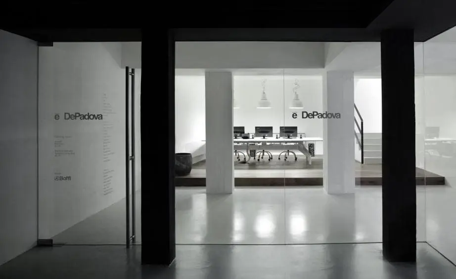 Glass-walled office entrance with a conference room visible inside