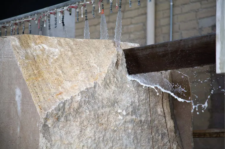 Marble block being cut with a water-cooled saw blade