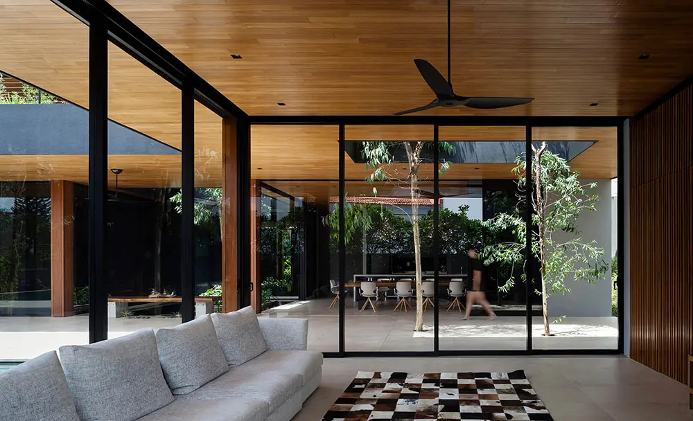 modern living room with a wood-clad courtyard view and a bamboo ceiling fan
