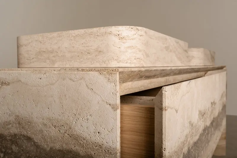 Close-up of a stone vanity's curved edge and drawer detail