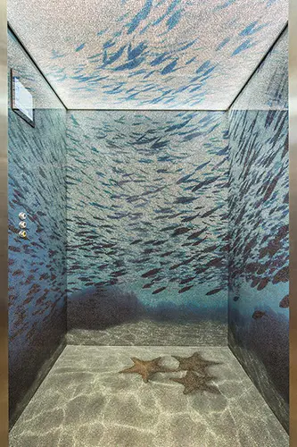 Elevator interior decorated with an underwater fish mural