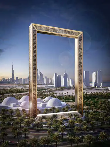 The Dubai Frame landmark viewed across palm trees and the city skyline