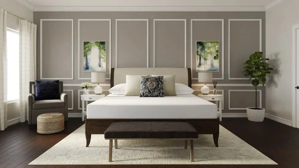 Staged bedroom with white bed, tufted headboard, botanical art and gray paneled wall