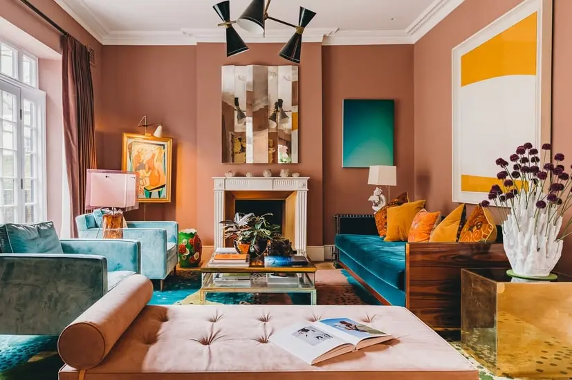 Eclectic living room with fireplace, blue sofa and colorful artwork