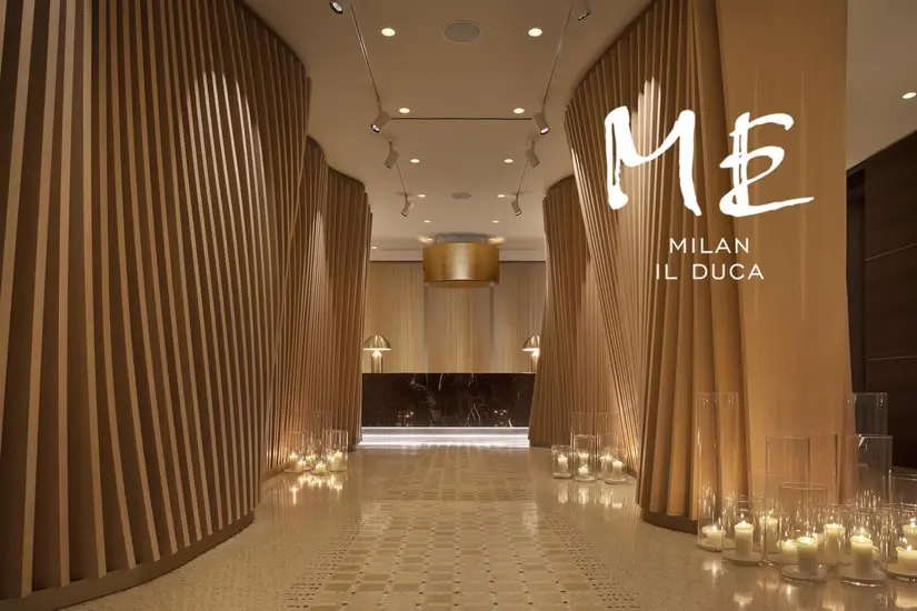 ME Milan Il Duca hotel corridor with wood slats and lit candles