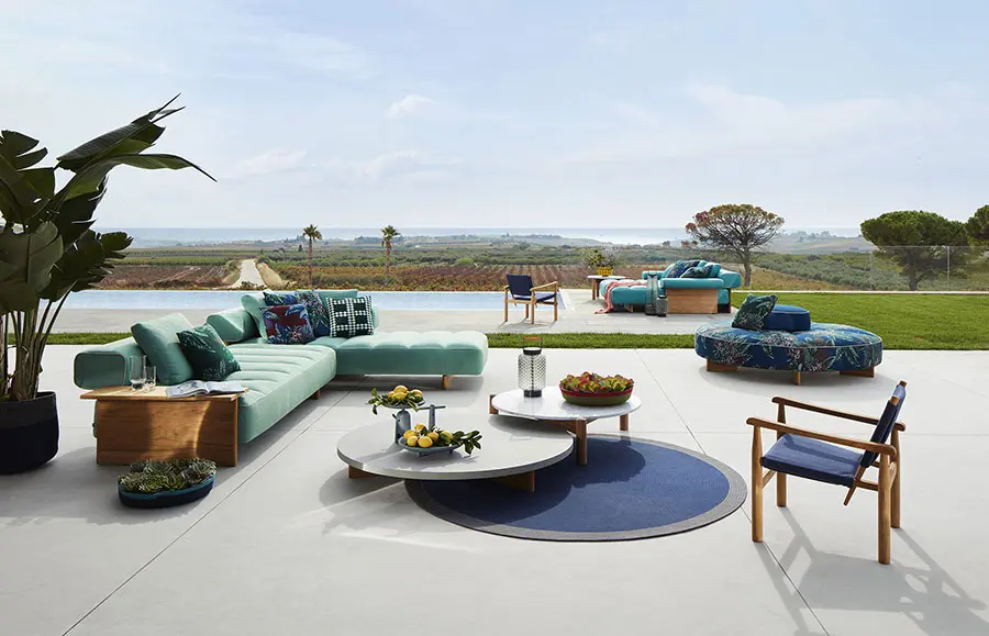 contemporary garden furniture produced by high end outdoor furniture brands on a terrace overlooking some green spaces