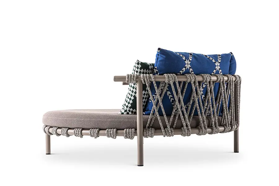 Outdoor rope-woven lounge chair and ottoman with blue patterned cushions