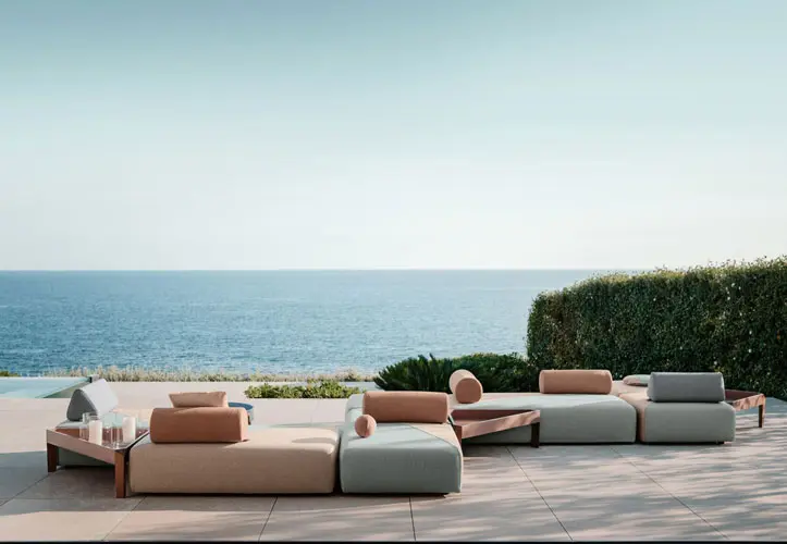 Outdoor lounge sofas on a terrace overlooking the ocean
