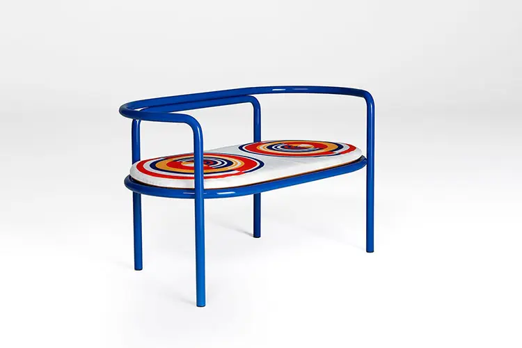 Blue tubular steel bench with a round multicolor cushion