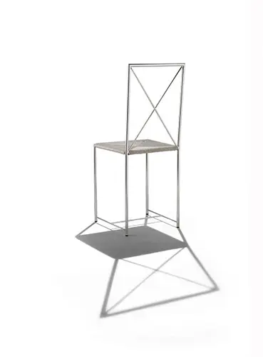 Chrome cross-frame outdoor chair with a woven seat casting a shadow
