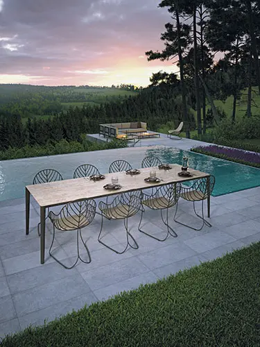 folia chair by royal botania next to a swimming pool overlooking a green forest