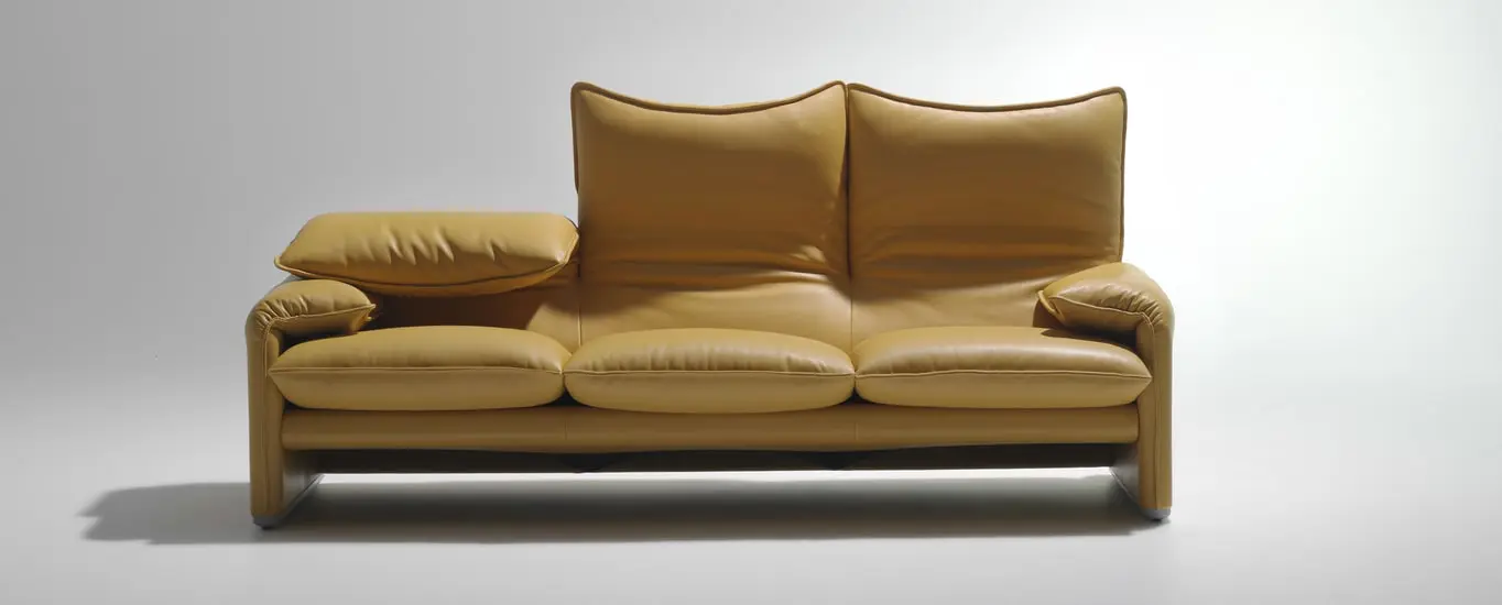 Cassina Maralunga sofa in mustard-yellow leather, with one headrest lowered to show the adjustable backrest