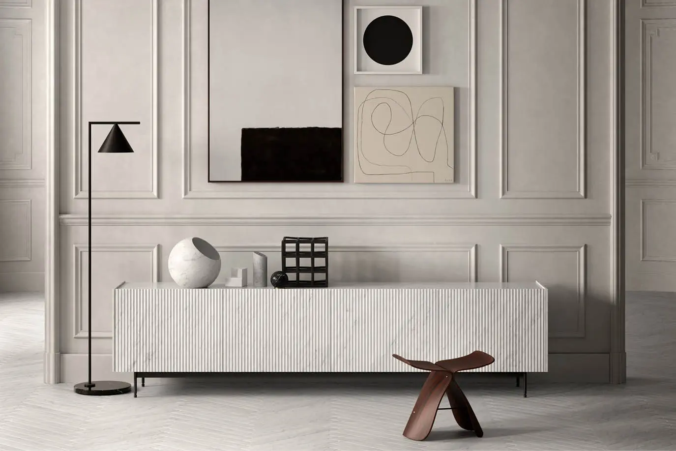 Living room wall with a white sideboard, abstract artworks and a wooden stool
