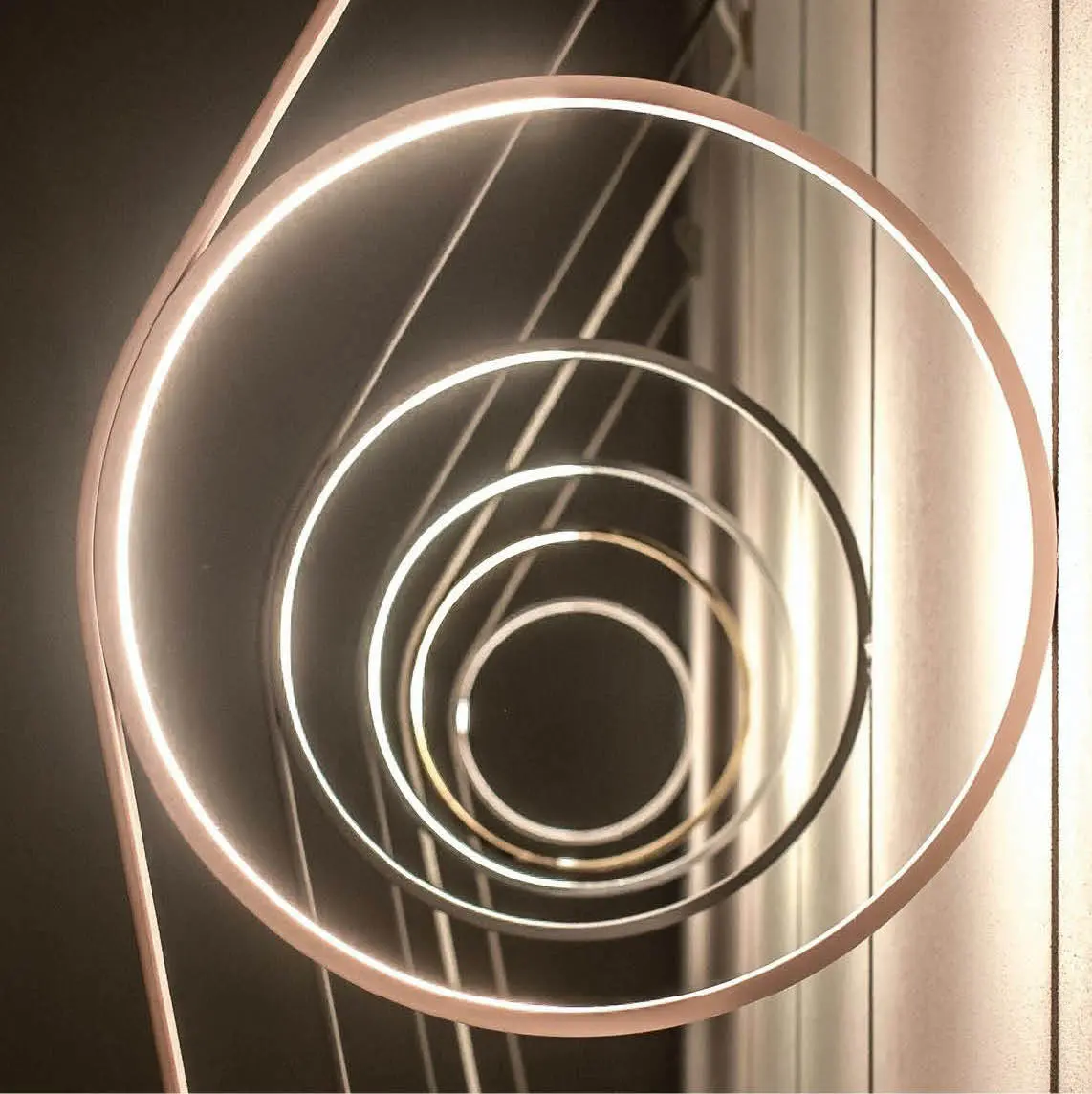 Circular brass pendant lights seen from below
