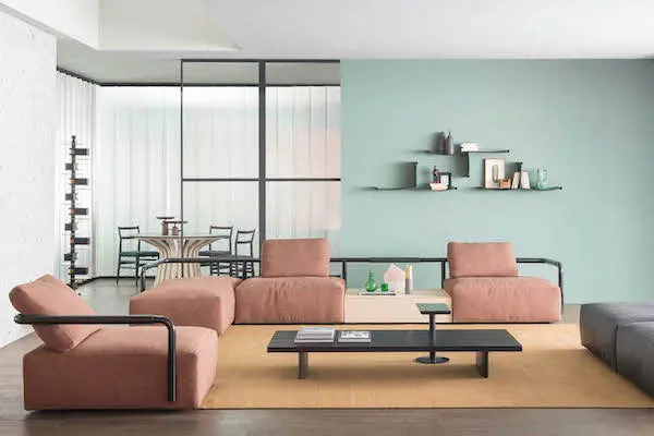 Terracotta modular sofa and coffee table in a living room with a teal accent wall