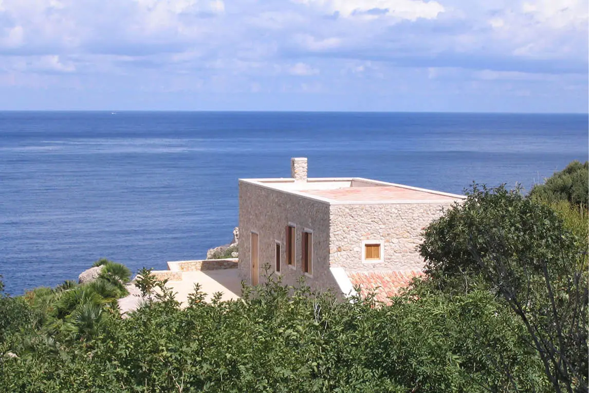 Stone villa on a hillside overlooking the sea