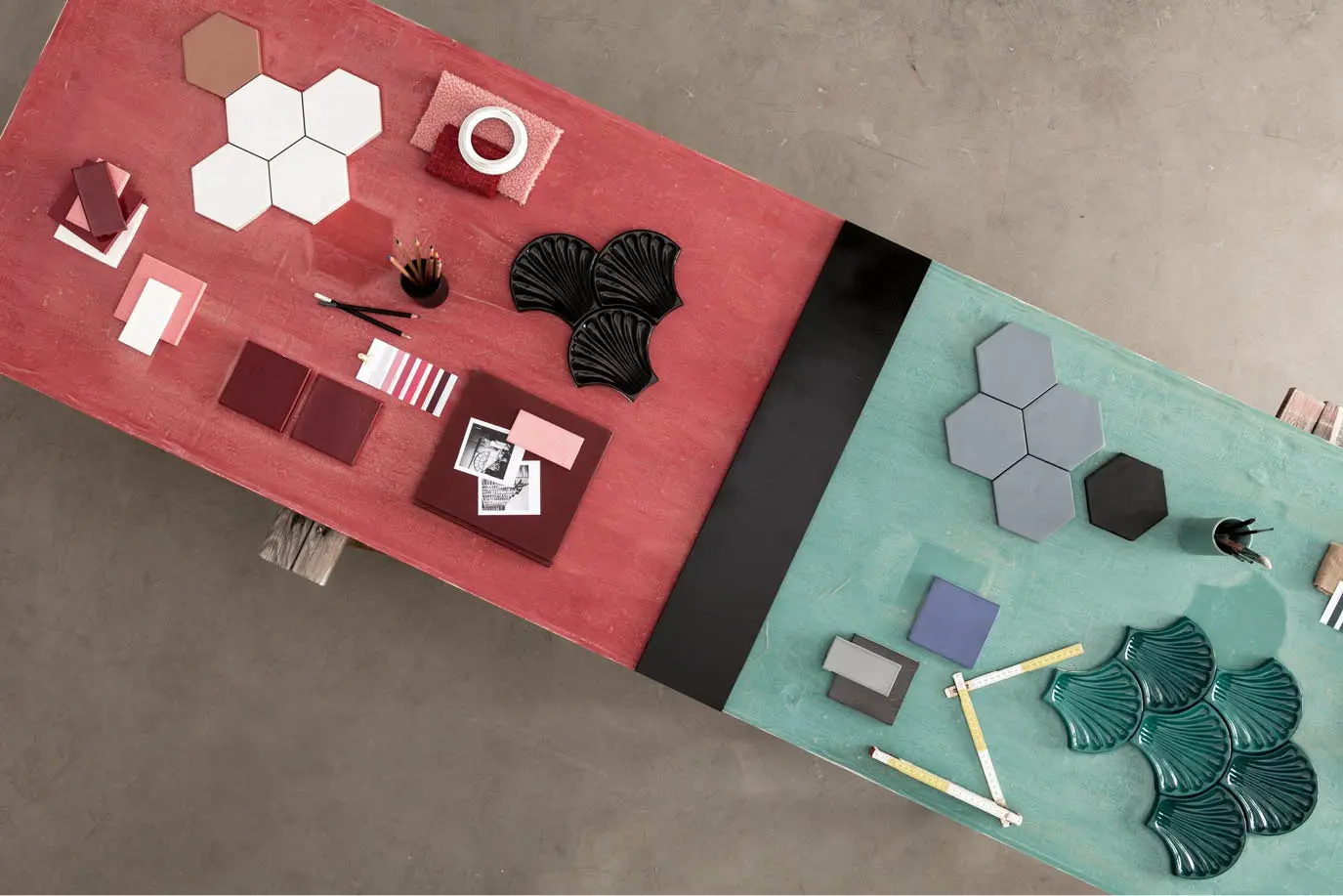Red and teal tile samples arranged on two coloured boards