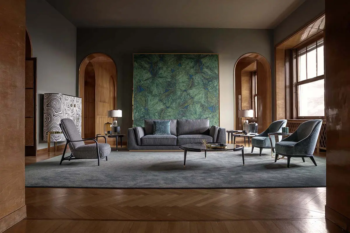 Living room with a grey sofa, arched wood doorways and a malachite-pattern cabinet