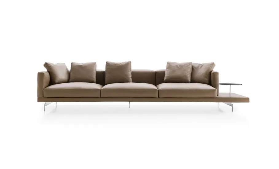 Taupe leather sofa with a built-in wooden side table on a white background