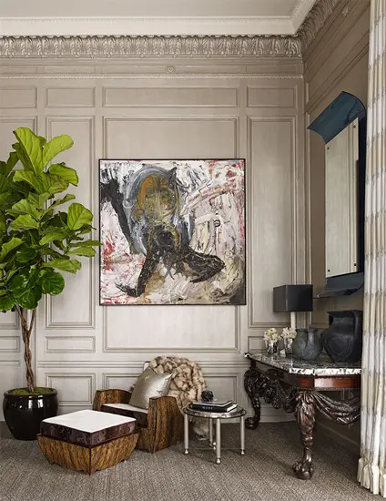 Entryway with an abstract portrait painting, a fiddle-leaf fig and an antique console table