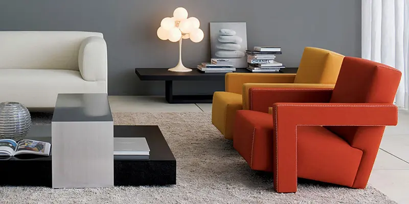 Living room with a white sofa and Cassina Utrecht armchairs in yellow and orange
