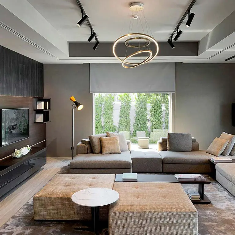 Molteni & C living room with a grey modular sofa, woven ottomans and a double ring pendant light