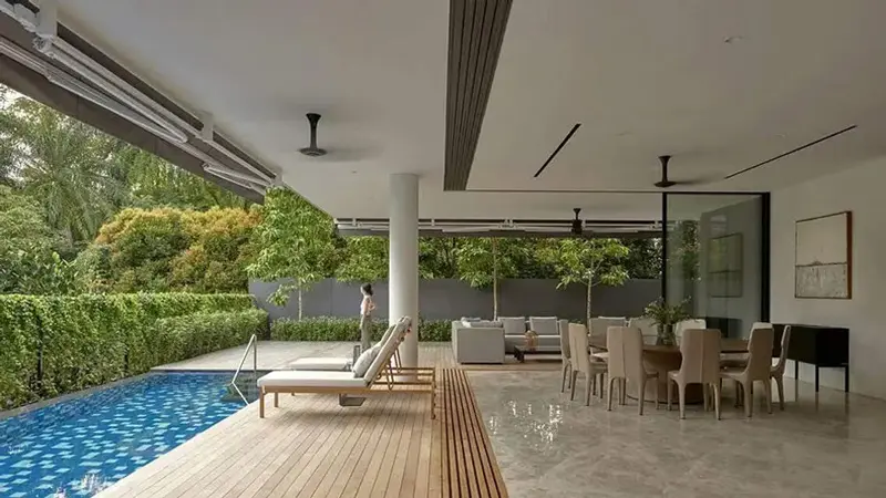 Covered poolside terrace with wooden deck, lounge chairs, sofa and dining table