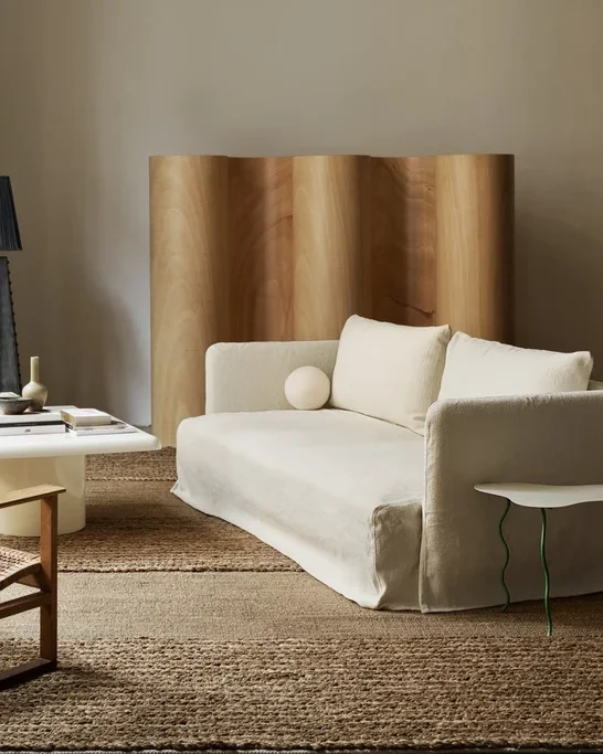 interior with a couch in the foreground with linen covers